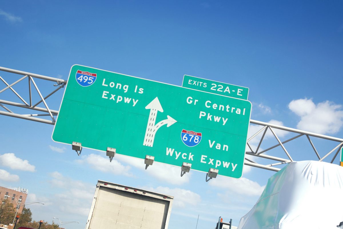 Low angle view of traffic sign at highway interchange, Queens, NY, USA.