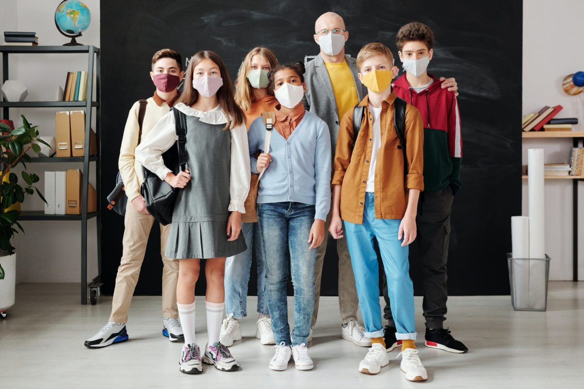 students and teacher wearing masks